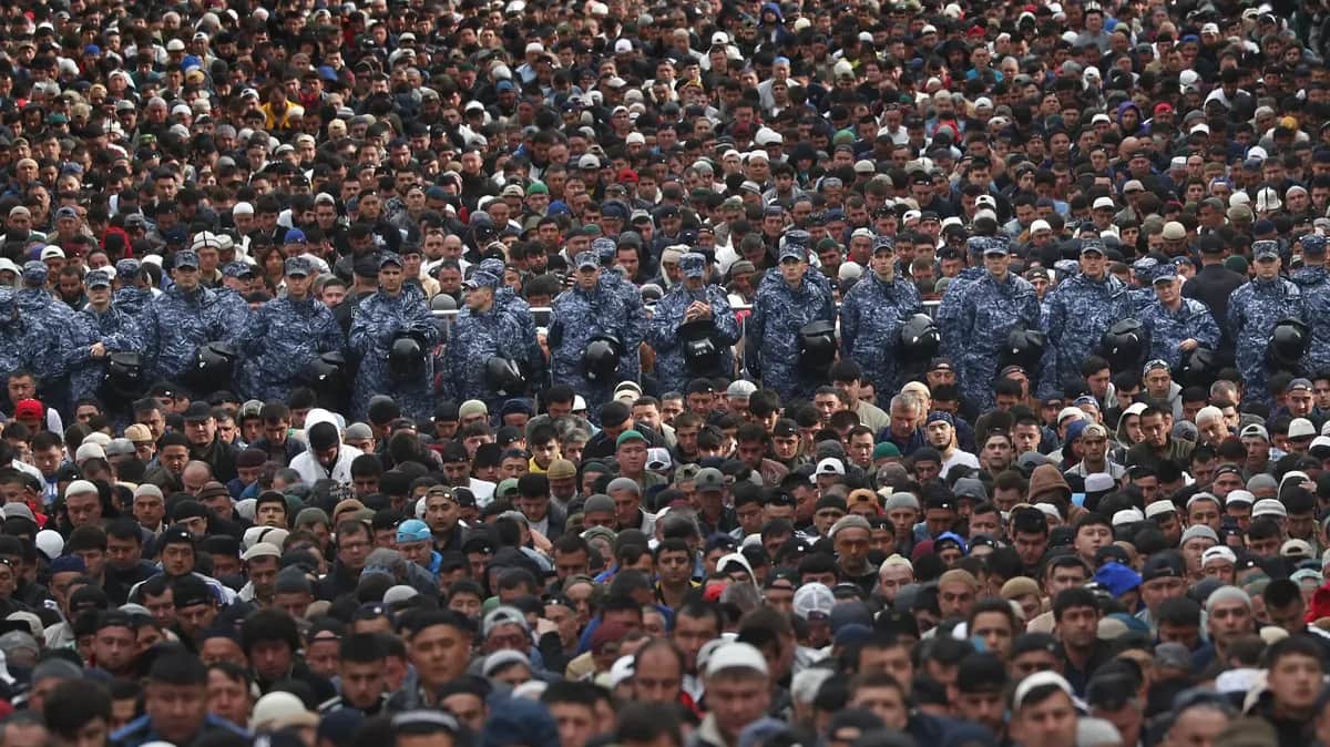 Police officers stand guard while Muslims attend morning prayers to celebrate Eid al-Adha near the Moscow's Sobornaya Mosque, 28 June 2023. Photo: EPA-EFE / MAXIM SHIPENKOV&nbsp;